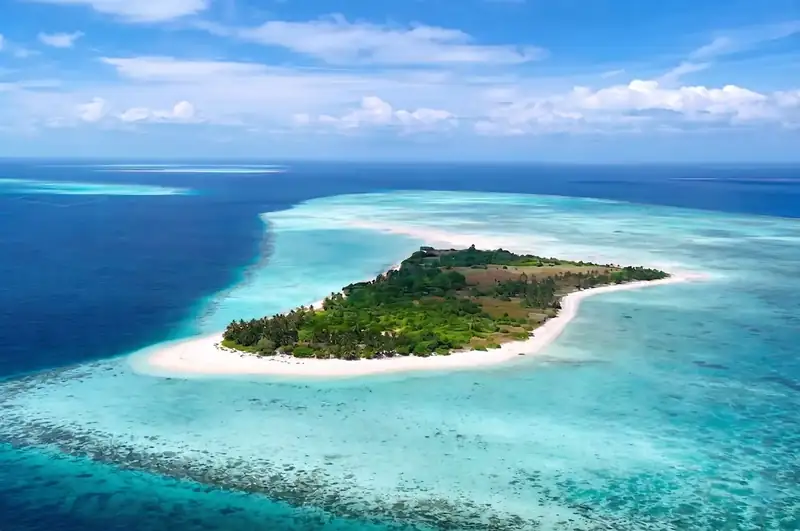 Crystal clear waters and white sand at Mantabuan Island Arcadia Beach Resort