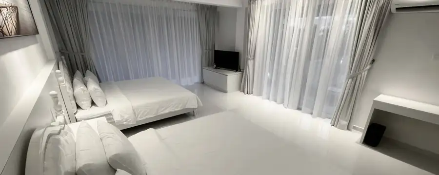 Bright white bedroom at Arcadia Beach Resort