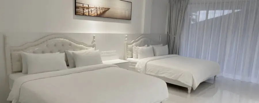 Elegant twin beds in ocean view room